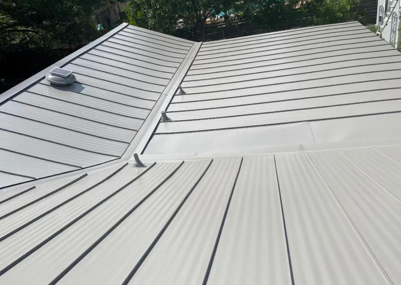 Solar attic fan installed on a metal roof for Roof Ventilation in Milo