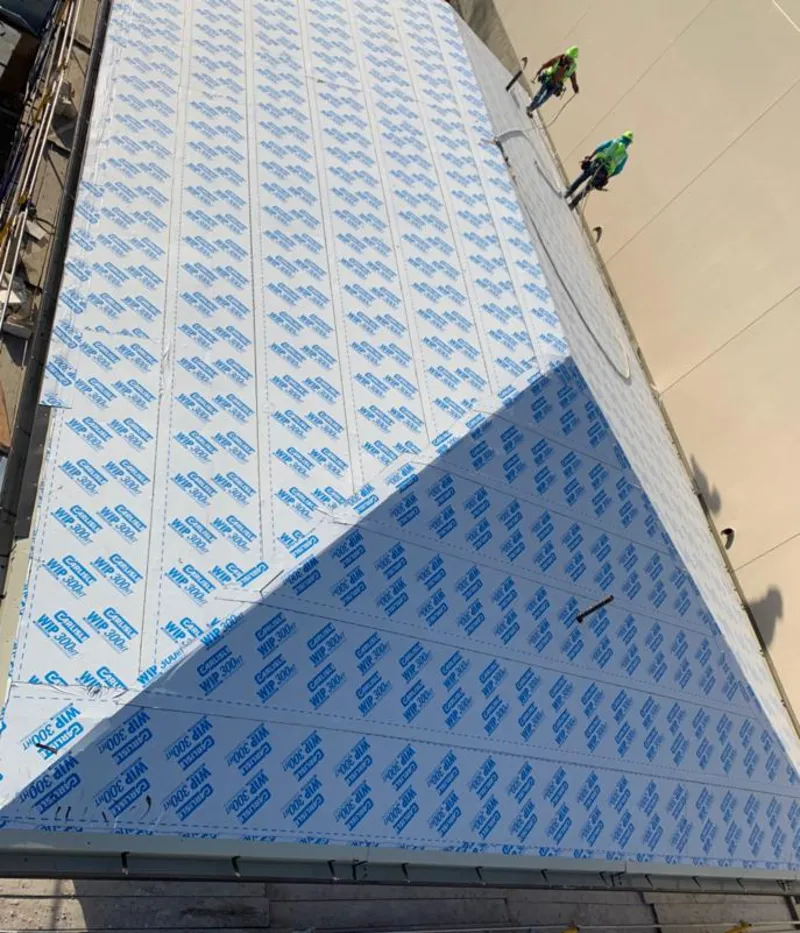 Professional roofers installing underlayment on a metal roof in Milo